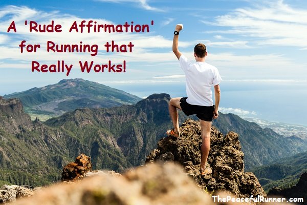 Athletic young man at top of mountain